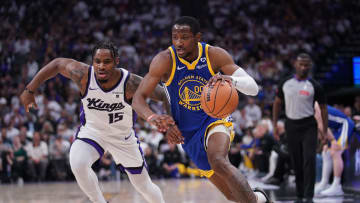 Apr 16, 2024; Sacramento, California, USA; Golden State Warriors forward Jonathan Kuminga (00) dribbles past Sacramento Kings guard Davion Mitchell (15) in the second quarter during a play-in game of the 2024 NBA playoffs at the Golden 1 Center. Mandatory Credit: Cary Edmondson-USA TODAY Sports