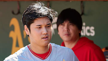Sep 3, 2023; Oakland, California, USA; Los Angeles Angels designated hitter Shohei Ohtani (17) and interpreter Ippei Mizuhara stand in the dugout before the game between the Los Angeles Angels and the Oakland Athletics at Oakland-Alameda County Coliseum. 
