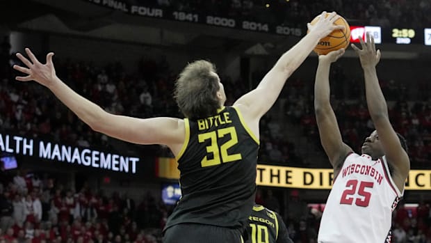 Oregon center Nate Bittle (32) blocks a shot by Wisconsin guard John Blackwell (25) during overtime