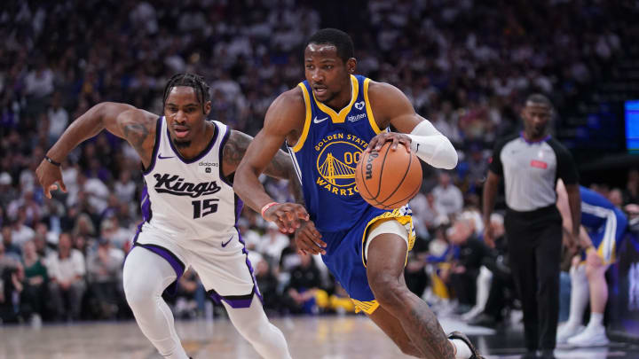 Apr 16, 2024; Sacramento, California, USA; Golden State Warriors forward Jonathan Kuminga (00) dribbles past Sacramento Kings guard Davion Mitchell (15) in the second quarter during a play-in game of the 2024 NBA playoffs at the Golden 1 Center. Mandatory Credit: Cary Edmondson-USA TODAY Sports