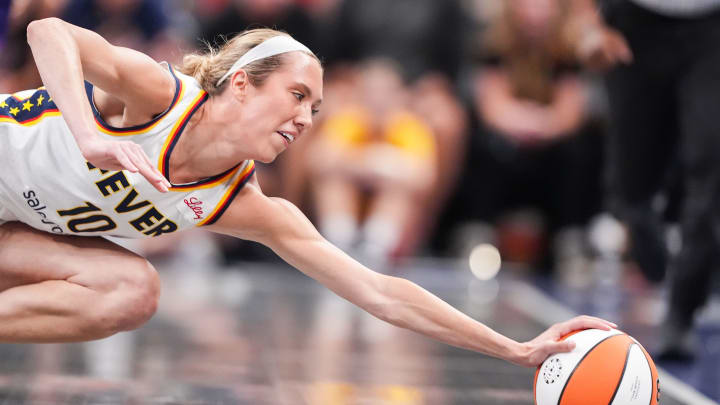 Indiana Fever guard Lexie Hull reaches for the ball as it rolls out of bounds.