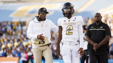 Head coach Deion Sanders and Shedeur Sanders #12 of the Colorado Buffaloes walk together prior to a game against the UCLA Bruins at Rose Bowl Stadium on October 28, 2023 in Pasadena, California.