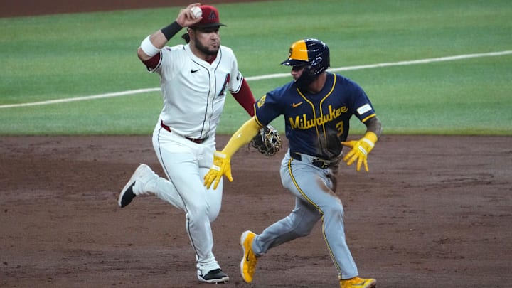 Sep 13, 2024; Phoenix, Arizona, USA; Arizona Diamondbacks third base Eugenio Suárez (28) runs down Milwaukee Brewers third base Joey Ortiz (3) during the fifth inning at Chase Field. Mandatory Credit: Joe Camporeale-Imagn Images