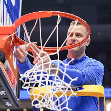 Duke Blue Devils head coach Jon Scheyer cuts down the net after the win over Louisville Cardinals during the 2025 ACC Conference Championship game.