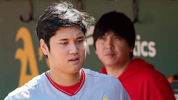 Los Angeles Angels designated hitter Shohei Ohtani (17) and interpreter Ippei Mizuhara stand in the dugout