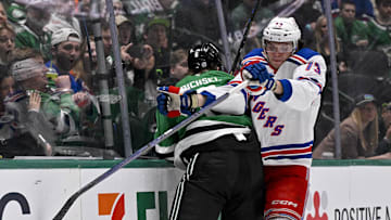 Dec 20, 2024; Dallas, Texas, USA; New York Rangers center Matt Rempe (73) checks Dallas Stars defenseman Lian Bichsel (6) during the first period at the American Airlines Center. Mandatory Credit: Jerome Miron-Imagn Images