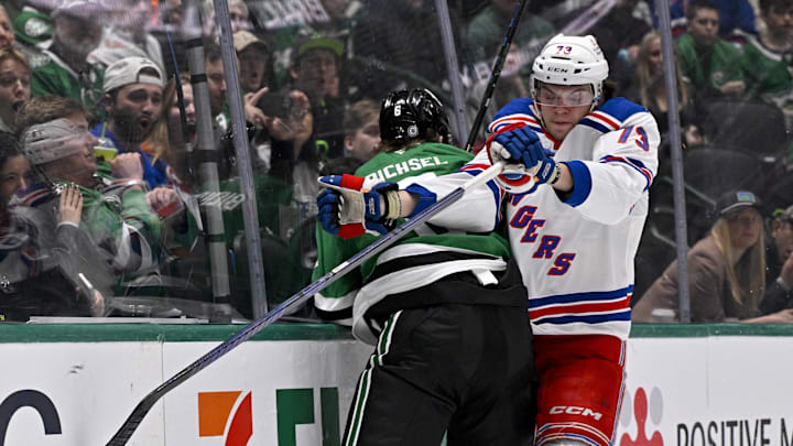Dec 20, 2024; Dallas, Texas, USA; New York Rangers center Matt Rempe (73) checks Dallas Stars defenseman Lian Bichsel (6) during the first period at the American Airlines Center. Mandatory Credit: Jerome Miron-Imagn Images