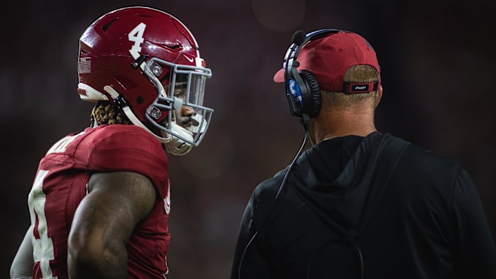 Sep 28, 2024; Tuscaloosa, Alabama, USA; Alabama Crimson Tide quarterback Jalen Milroe (4) talks with head coach Kalen DeBoer during a timeout in the third quarter against the Georgia Bulldogs at Bryant-Denny Stadium. Mandatory Credit: Will McLelland-Imagn Images