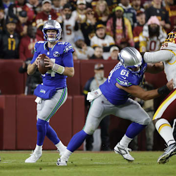 Nov 2, 2025; Landover, Maryland, USA; Seattle Seahawks quarterback Sam Darnold (14) looks to pass during the first half against the Washington Commanders during the first half at Northwest Stadium. Mandatory Credit: Amber Searls-Imagn Images