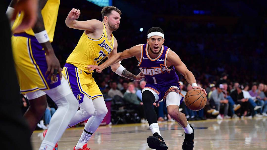 Dec 1, 2025; Los Angeles, California, USA; Phoenix Suns guard Devin Booker (1) moves to the basket against Los Angeles Lakers guard Luka Doncic (77) during the first half at Crypto.com Arena. Mandatory Credit: Gary A. Vasquez-Imagn Images Dec 1, 2025; Los Angeles, California, USA; Phoenix Suns guard Devin Booker (1) moves to the basket against Los Angeles Lakers guard Luka Doncic (77) during the first half at Crypto.com Arena. Mandatory Credit: Gary A. Vasquez-Imagn Images