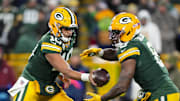 Nov 10, 2025; Green Bay, Wisconsin, USA;  Green Bay Packers quarterback Jordan Love (10) hands the football off to running back Josh Jacobs (8) during the game against the Philadelphia Eagles at Lambeau Field.  