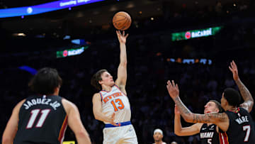 Oct 26, 2025; Miami, Florida, USA; New York Knicks guard Tyler Kolek (13) shoots the basketball over Miami Heat center Kel'el Ware (7) and forward Nikola Jovic (5) during the third quarter at Kaseya Center. Mandatory Credit: Sam Navarro-Imagn Images