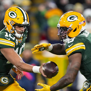 Nov 10, 2025; Green Bay, Wisconsin, USA;  Green Bay Packers quarterback Jordan Love (10) hands the football off to running back Josh Jacobs (8) during the game against the Philadelphia Eagles at Lambeau Field.  