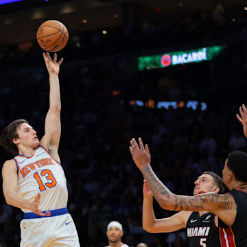 Oct 26, 2025; Miami, Florida, USA; New York Knicks guard Tyler Kolek (13) shoots the basketball over Miami Heat center Kel'el Ware (7) and forward Nikola Jovic (5) during the third quarter at Kaseya Center. Mandatory Credit: Sam Navarro-Imagn Images