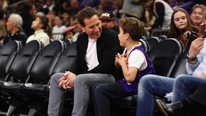 Dec 27, 2024; Phoenix, Arizona, USA; Phoenix Suns owner Mat Ishbia sits courtside with his son against the Dallas Mavericks at Footprint Center. Mandatory Credit: Mark J. Rebilas-Imagn Images