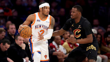 Apr 11, 2025; New York, New York, USA; New York Knicks guard Miles McBride (2) controls the ball against Cleveland Cavaliers guard Javonte Green (8) during the second quarter at Madison Square Garden. Mandatory Credit: Brad Penner-Imagn Images