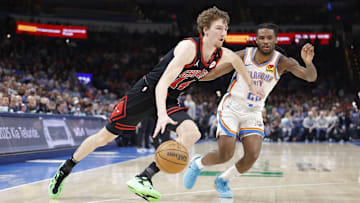 Mar 31, 2025; Oklahoma City, Oklahoma, USA; Chicago Bulls forward Matas Buzelis (14) drives to the basket around Oklahoma City Thunder guard Cason Wallace (22)