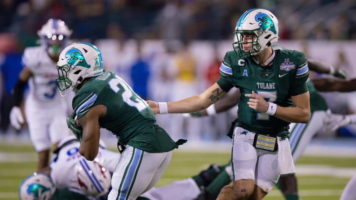 Dec 2, 2023; New Orleans, LA, USA; Tulane Green Wave quarterback Michael Pratt (7) hands the ball off against the Southern Methodist Mustangs during the second half at Yulman Stadium. 