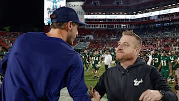 Tampa, Florida, USA;  South Florida Bulls head coach Alex Golesh (right) shakes the hand of Florida Atlantic Owls head coach Zach Kittley after the game at Raymond James Stadium. 