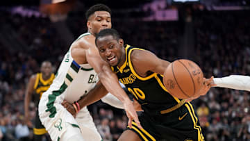 Mar 6, 2024; San Francisco, California, USA; Golden State Warriors forward Jonathan Kuminga (00) loses control of the ball next to Milwaukee Bucks forward Giannis Antetokounmpo (34) in the third quarter at the Chase Center. Mandatory Credit: Cary Edmondson-Imagn Images