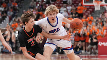 Wisconsin Lutheran's Kager Knueppel (1) battles to get past Marshfield's Joey Ketterer (2) in their WIAA Division 1 state championship boys basketball game, Saturday, March 22, 2025, at the Kohl Center in Madison, Wis. Wisconsin Lutheran won the game, 57-55.