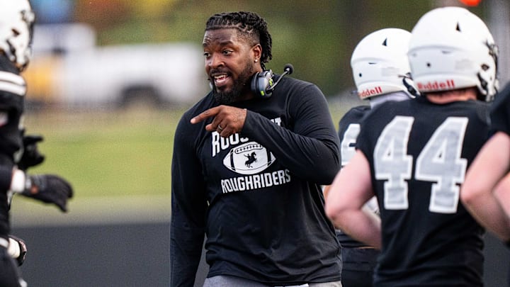 Roosevelt head coach Ernst Brun talks with his players during a game against Waukee Northwest on Thursday, Sept. 12, 2024, at Mediacom Stadium in Des Moines.