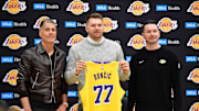 Feb 4, 2025; El Segundo, CA, USA; Los Angeles Lakers guard Luka Doncic poses for photos with general manager Rob Pelinka and head coach JJ Redick at UCLA Health Training Center. Mandatory Credit: Gary A. Vasquez-Imagn Images