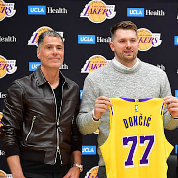 Feb 4, 2025; El Segundo, CA, USA; Los Angeles Lakers guard Luka Doncic poses for photos with general manager Rob Pelinka and head coach JJ Redick at UCLA Health Training Center. Mandatory Credit: Gary A. Vasquez-Imagn Images