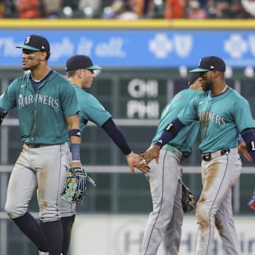 Seattle Mariners center fielder Julio Rodriguez (44) celebrates with first baseman Luke Raley (20) after the game against the Houston Astros at Minute Maid Park in 2024.