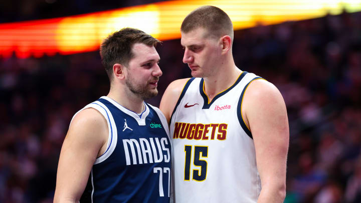 Dallas Mavericks guard Luka Doncic (77) speaks with Denver Nuggets center Nikola Jokic (15) during the second half at American Airlines Center. Mandatory Credit: