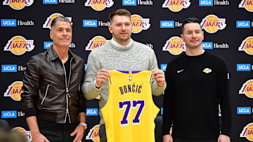 Feb 4, 2025; El Segundo, CA, USA; Los Angeles Lakers guard Luka Doncic poses for photos with general manager Rob Pelinka and head coach JJ Redick at UCLA Health Training Center. Mandatory Credit: Gary A. Vasquez-Imagn Images