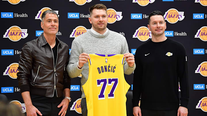 Feb 4, 2025: Los Angeles Lakers guard Luka Doncic poses for photos with general manager Rob Pelinka and head coach JJ Redick.