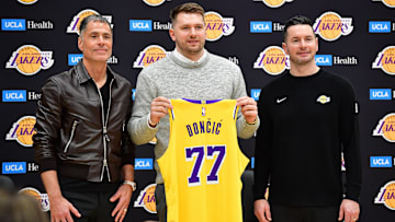 Feb 4, 2025; El Segundo, CA, USA; Los Angeles Lakers guard Luka Doncic poses for photos with general manager Rob Pelinka and head coach JJ Redick at UCLA Health Training Center. Mandatory Credit: Gary A. Vasquez-Imagn Images