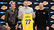 Feb 4, 2025; El Segundo, CA, USA; Los Angeles Lakers guard Luka Doncic poses for photos with general manager Rob Pelinka and head coach JJ Redick at UCLA Health Training Center. Mandatory Credit: Gary A. Vasquez-Imagn Images