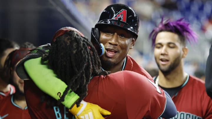 Aug 21, 2024; Miami, Florida, USA;  Arizona Diamondbacks shortstop Geraldo Perdomo (2) gets a hug frim teammate Josh Bell (36) after hitting a home run against the Miami Marlins in the eighth inning at loanDepot Park. Mandatory Credit: Rhona Wise-USA TODAY Sports