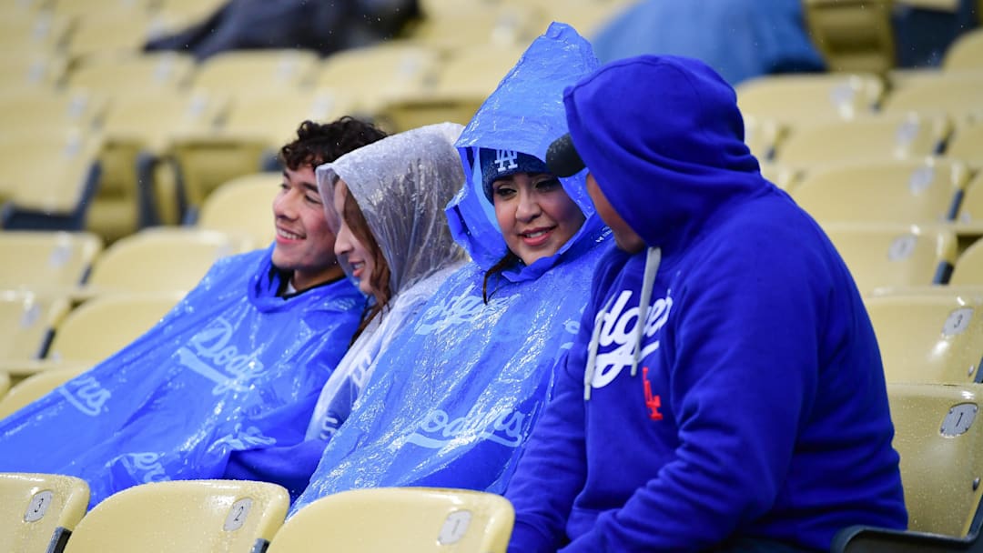 Apr 13, 2024; Los Angeles, California, USA; Spectators wait out a rain delay before the Los Angeles Dodgers play against the San Diego Padres at Dodger Stadium. Mandatory Credit: Gary A. Vasquez-Imagn Images