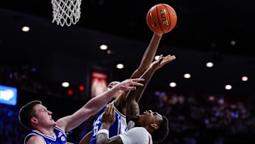 Nov 22, 2024; Tucson, Arizona, USA; Arizona Wildcats guard KJ Lewis (5) attempts to make a basket while Duke Blue Devils forward Maliq Brown (6) blocks him during the second quarter at McKale Center. Mandatory Credit: Aryanna Frank-Imagn Images