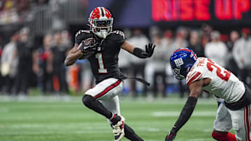 Dec 22, 2024; Atlanta, Georgia, USA; Atlanta Falcons wide receiver Darnell Mooney (1) runs against New York Giants safety Jason Pinnock (27) after a catch during the first half at Mercedes-Benz Stadium. Mandatory Credit: Dale Zanine-Imagn Images