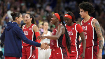 Aug 4, 2024; Villeneuve-d'Ascq, France; United States shooting guard Diana Taurasi (12) celebrates with forward guard Jackie Young (13) and forward Kahleah Copper (7) and centre Brittney Griner (15) after defeating Germany in a women’s group C game during the Paris 2024 Olympic Summer Games at Stade Pierre-Mauroy. Mandatory Credit: John David Mercer-USA TODAY Sports