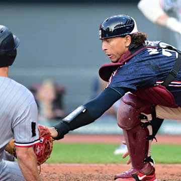 Aug 1, 2025; Cleveland, Ohio, USA; Cleveland Guardians catcher Bo Naylor (23) tags out Minnesota Twins shortstop Brooks Lee (2) during the third inning at Progressive Field. Mandatory Credit: Ken Blaze-Imagn Images