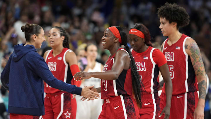 Aug 4, 2024; Villeneuve-d'Ascq, France; United States shooting guard Diana Taurasi (12) celebrates with forward guard Jackie Young (13) and forward Kahleah Copper (7) and centre Brittney Griner (15) after defeating Germany in a women’s group C game during the Paris 2024 Olympic Summer Games at Stade Pierre-Mauroy. Mandatory Credit: John David Mercer-USA TODAY Sports