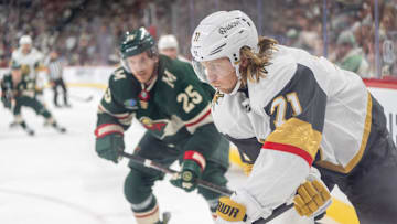 Apr 24, 2025; Saint Paul, Minnesota, USA; Vegas Golden Knights center Brett Howden (21) plays the puck in the corner as Minnesota Wild defenseman Jonas Brodin (25) defends on the play in the third period in game three of the first round of the 2025 Stanley Cup Playoffs at Xcel Energy Center. Mandatory Credit: Matt Blewett-Imagn Images