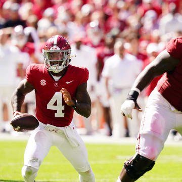 Oct 14, 2023; Tuscaloosa, Alabama, USA; Alabama Crimson Tide quarterback Jalen Milroe (4) runs out of the pocket against the Arkansas Razorbacks during the second half at Bryant-Denny Stadium. Mandatory Credit: John David Mercer-USA TODAY Sports