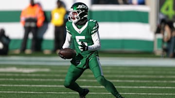 Dec 22, 2024; East Rutherford, New Jersey, USA; New York Jets wide receiver Garrett Wilson (5) gains yards after catch during the first half against the Los Angeles Rams at MetLife Stadium. Mandatory Credit: Vincent Carchietta-Imagn Images