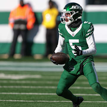 Dec 22, 2024; East Rutherford, New Jersey, USA; New York Jets wide receiver Garrett Wilson (5) gains yards after catch during the first half against the Los Angeles Rams at MetLife Stadium. Mandatory Credit: Vincent Carchietta-Imagn Images