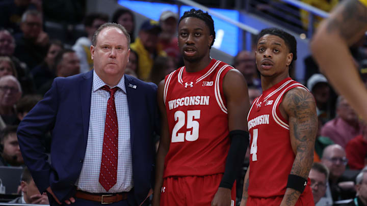 Mar 16, 2025; Indianapolis, IN, USA; Wisconsin Badgers head coach Greg Gard, guard John Blackwell (25) and guard Kamari McGee (4) talk during a pause in play during the second half against the Michigan Wolverines during the 2025 Big Ten Championship Game at Gainbridge Fieldhouse. Mandatory Credit: Trevor Ruszkowski-Imagn Images