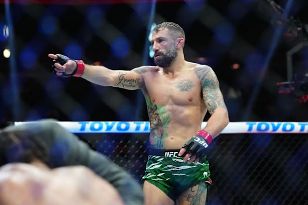Michael Chiesa (red gloves) reacts after defeating Max Griffin (blue gloves) at T-Mobile Arena.