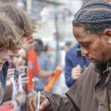 Feb 22, 2025; West Palm Beach, Florida, USA;Rap artist Travis Scott signs autographs 