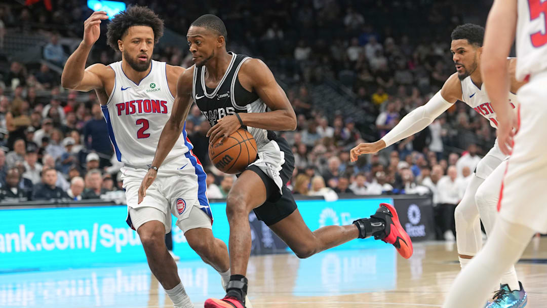 Mar 5, 2026; San Antonio, Texas, USA; San Antonio Spurs guard De’Aaron Fox (4) drives to the basket against Detroit Pistons guard Cade Cunningham (2) during the first half at Frost Bank Center. Mandatory Credit: Scott Wachter-Imagn Images
