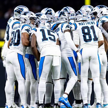 Sep 8, 2024; New Orleans, Louisiana, USA;  Carolina Panthers quarterback Bryce Young (9) calls a play in the huddle with wide receiver Jonathan Mingo (15) against the New Orleans Saints during the first half at Caesars Superdome. 